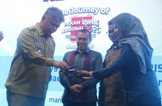 Wakil Bupati Tapanuli Utara Dr. Deni Parlindungan Lumbantoruan, M.Eng mencoba transaksi pembayaran melalui QRIS saat acara Kick Off The Journey of Pekan QRIS Nasional 2025 di Gedung Sopo Partungkoan, Tarutung, Senin (11/8/2025). (Foto:Loksa Situmeang)